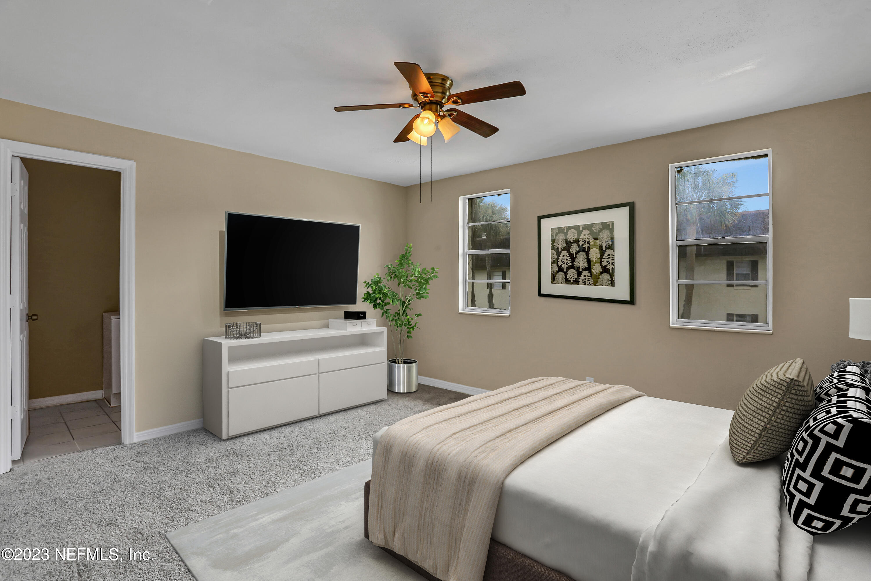 1735 El Camino Road, Unit 5 Jacksonville, FL 32216 - Photo 6 of 32 a bedroom with a bed and a flat screen tv