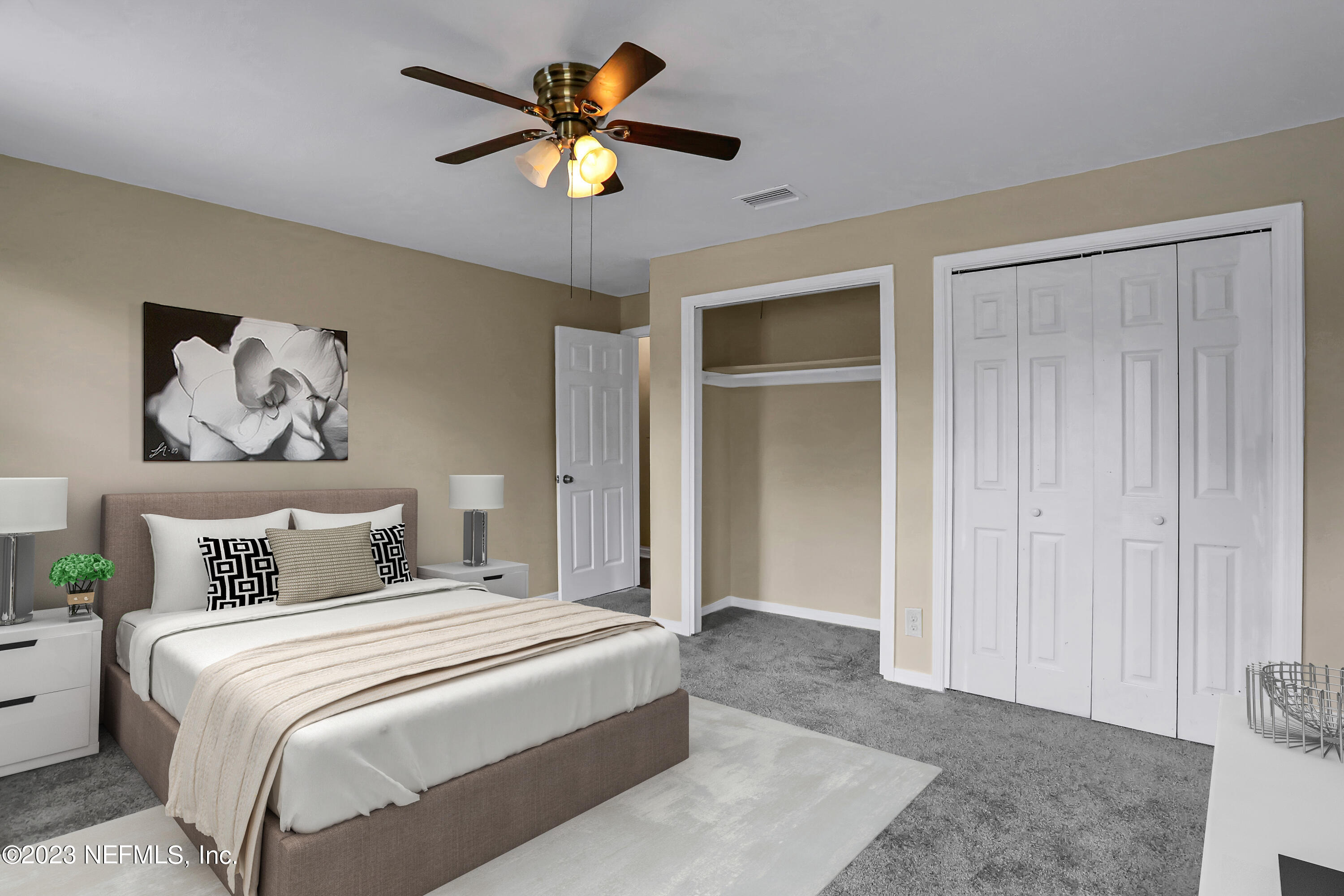 1735 El Camino Road, Unit 5 Jacksonville, FL 32216 - Photo 7 of 32 a bedroom with a bed and a chandelier