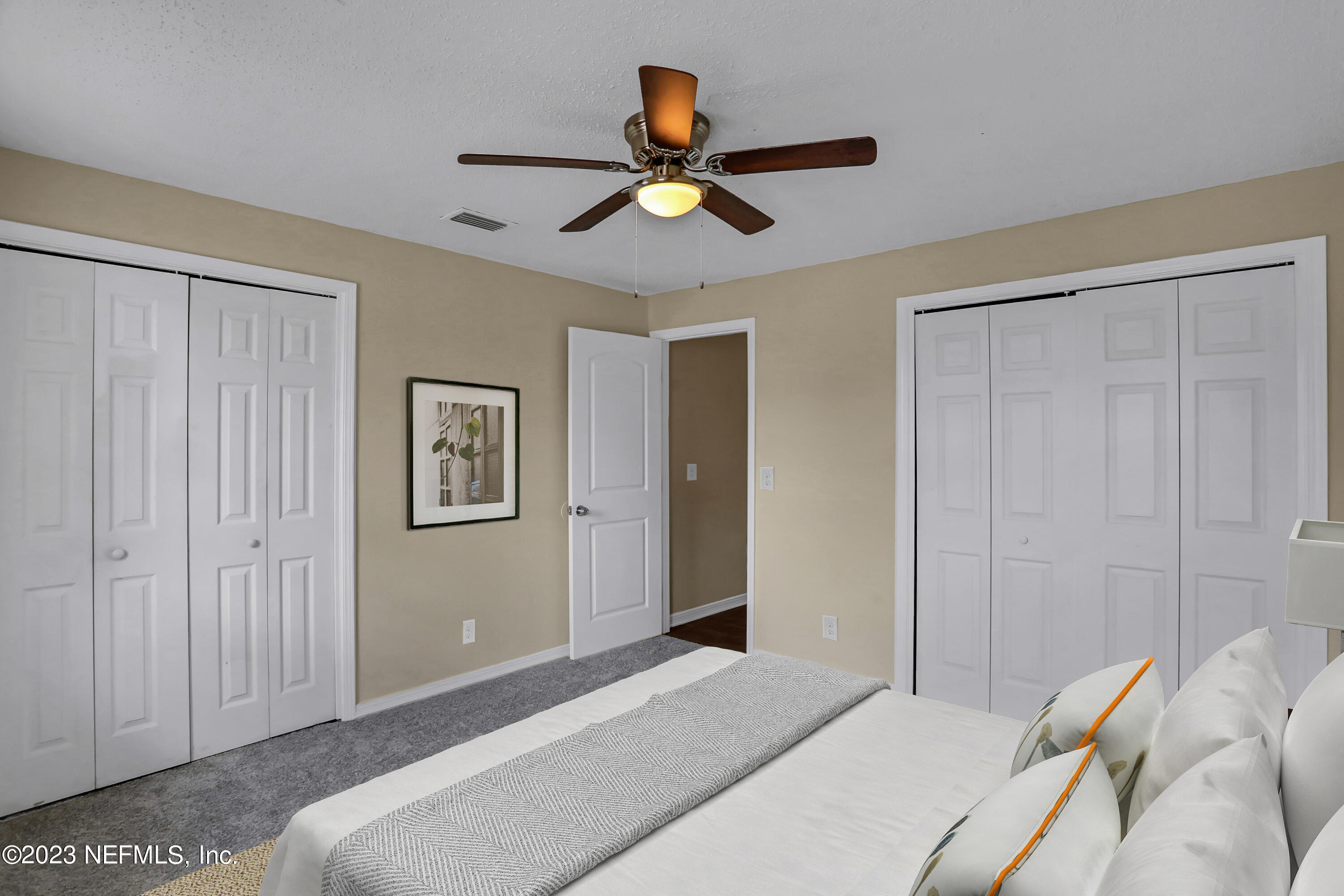 1735 El Camino Road, Unit 5 Jacksonville, FL 32216 - Photo 8 of 32 a bedroom with a bed and a chandelier