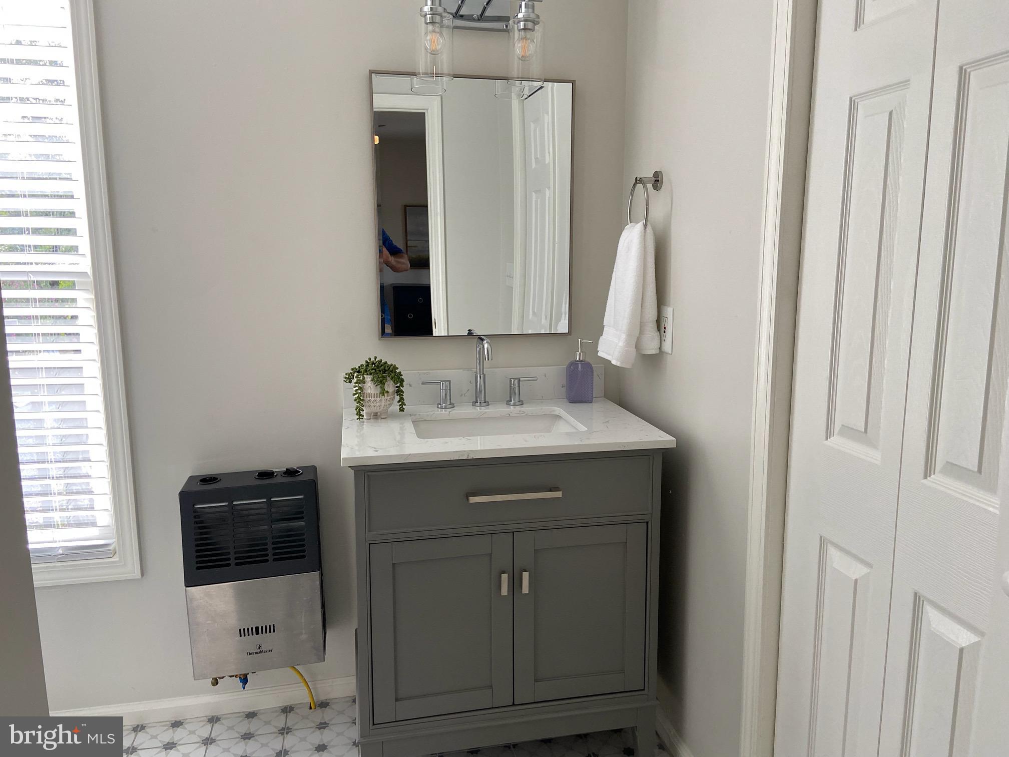 271 Ogden Farm Road Moorefield, WV 26836 - Photo 39 of 50 a bathroom with a sink a vanity and a mirror