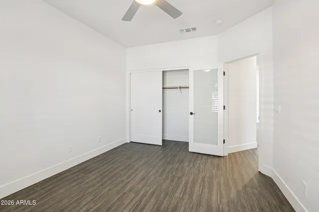 wooden floor in an empty room with a fireplace