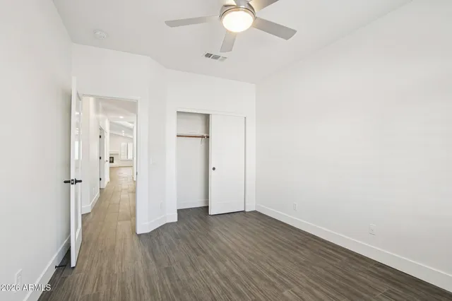 an empty room with wooden floor