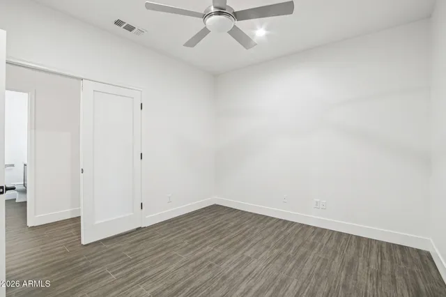 a view of an empty room and wooden floor