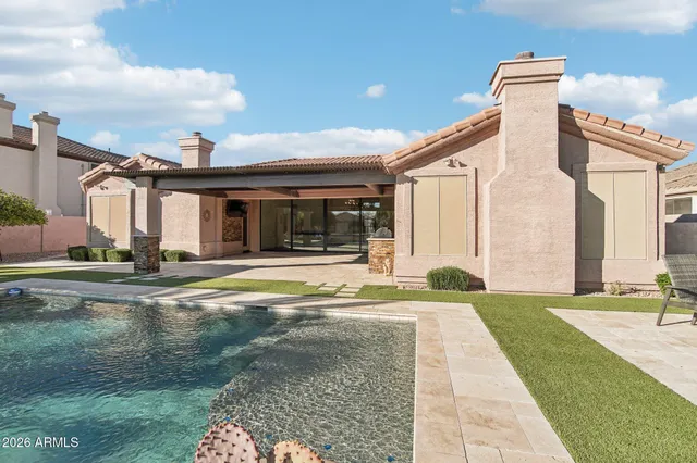 a view of a house with a swimming pool and a yard