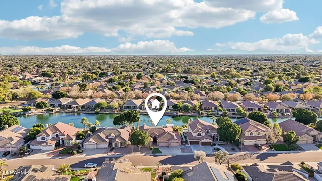 an aerial view of a city with lots of residential buildings ocean and mountain view in back