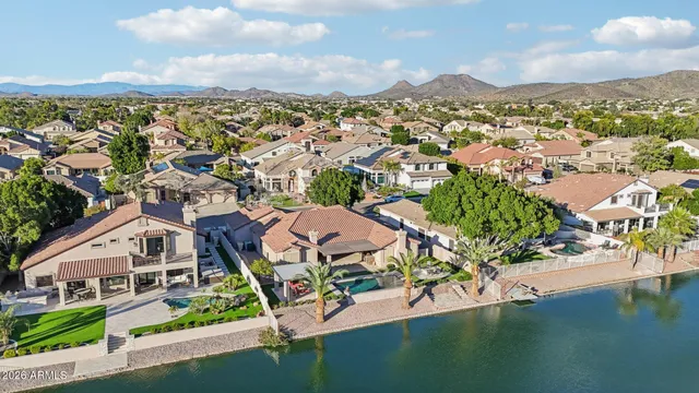 an aerial view of residential houses with outdoor space and swimming pool