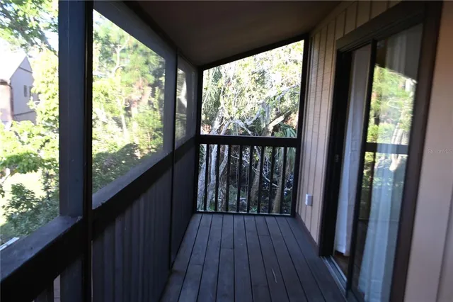 a view of balcony with wooden floor