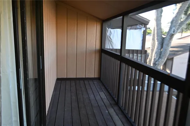 a view of a balcony with wooden floor