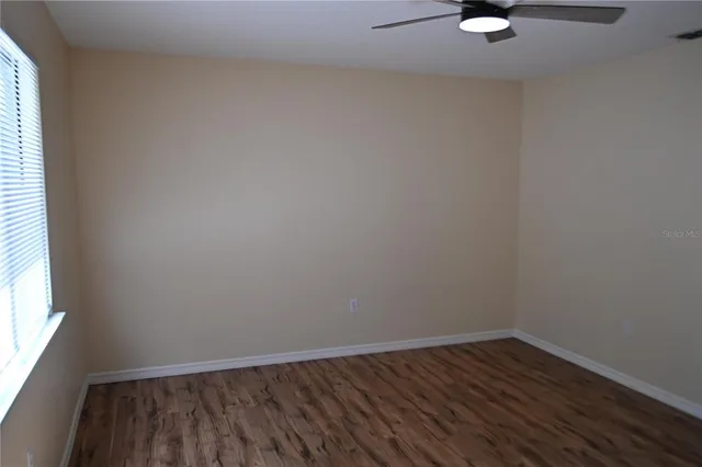 a view of a room with wooden floor