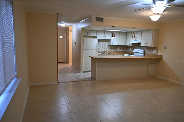 a kitchen with kitchen island a sink stainless steel appliances and cabinets