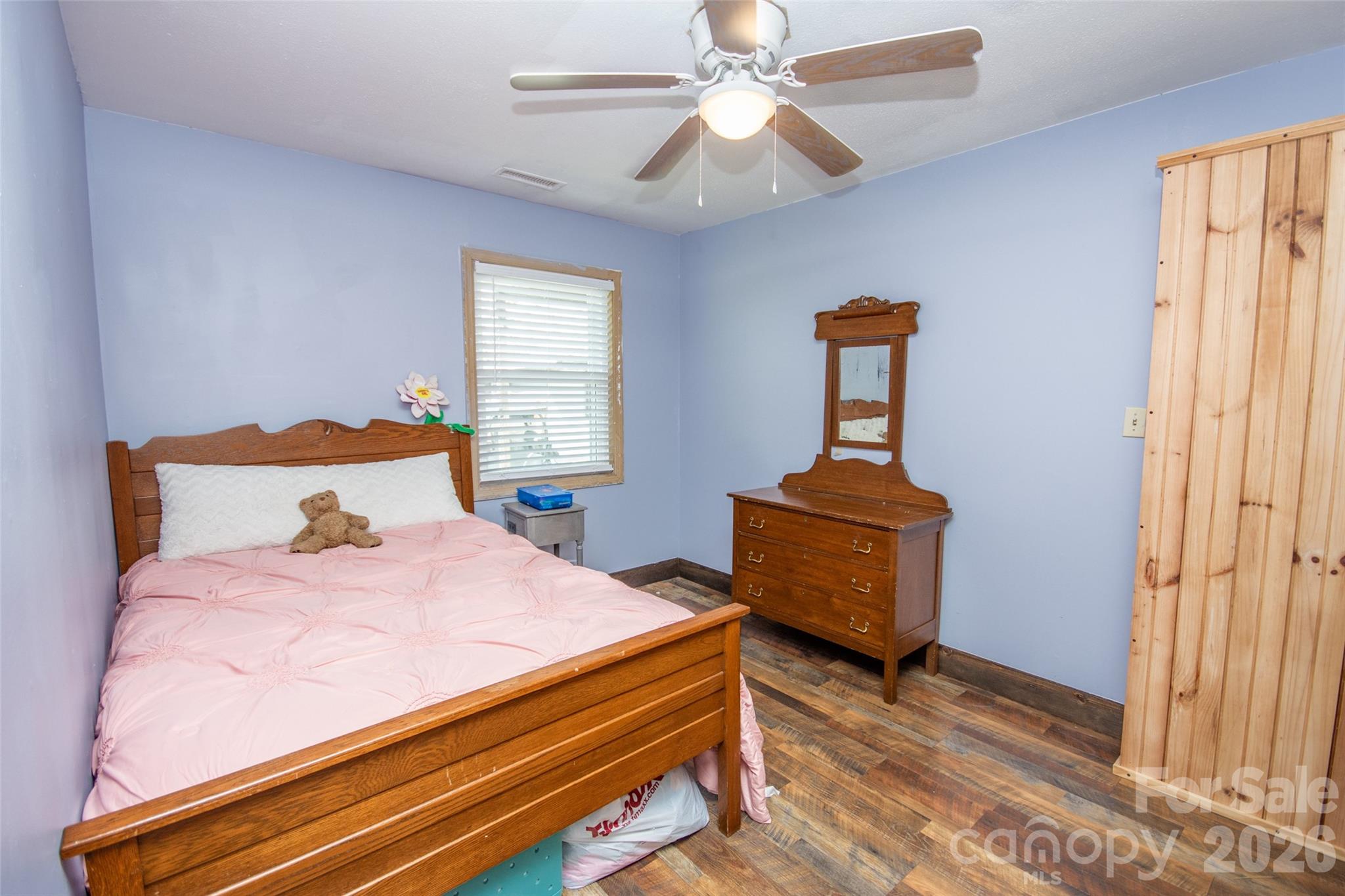 120 Mitch Road Union Grove, NC 28689 - Photo 17 of 24 a bedroom with a bed and a chandelier