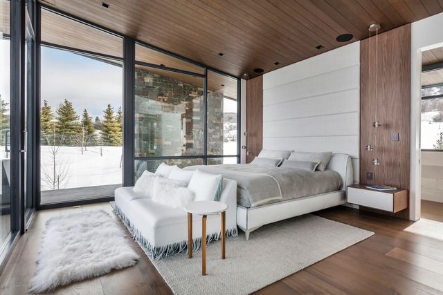 a bathroom with a tub a sink and a large mirror