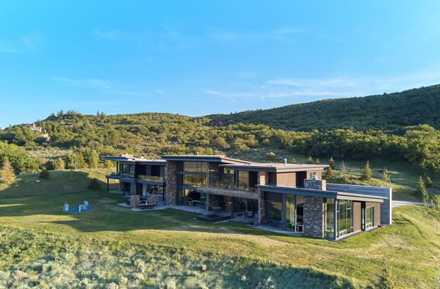 a view of a chairs and table in back yard of the house