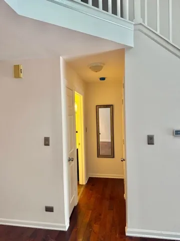 a view of a room with wooden floor