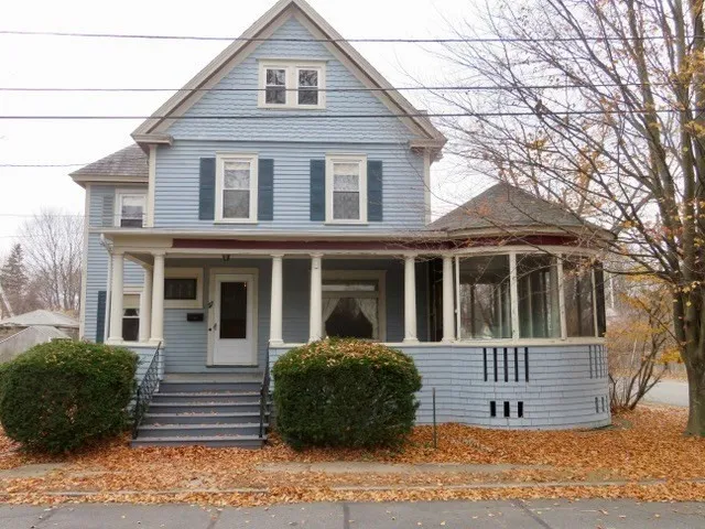 a view of a white house with large windows