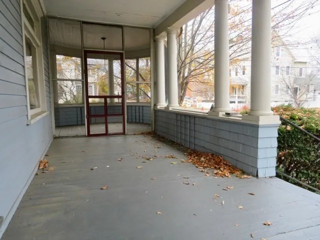 a wooden bench sitting in front of a building