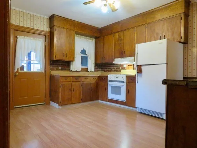 a kitchen with kitchen island a counter top space a sink stainless steel appliances and cabinets