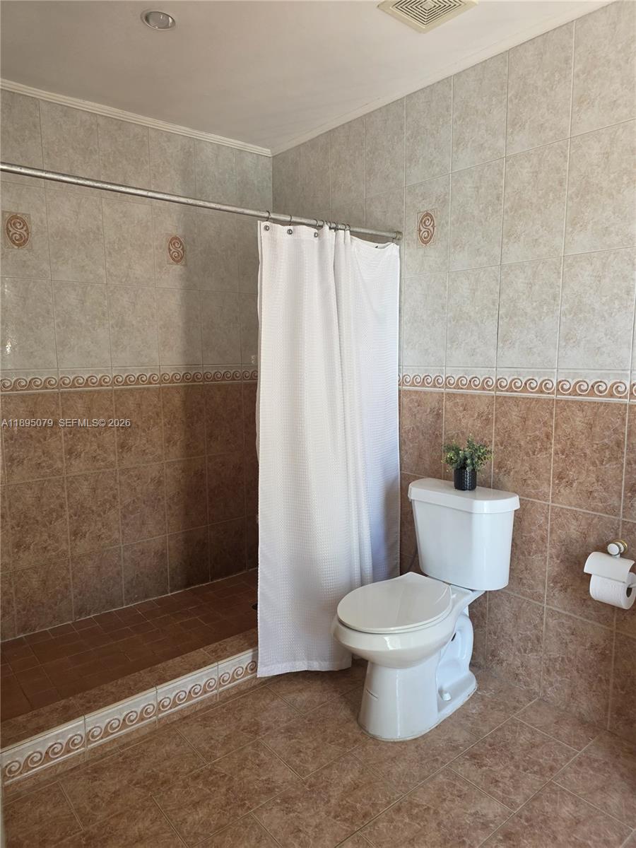 12941 Auralia Road North Miami, FL 33181 - Photo 12 of 32 a bathroom with a toilet and a shower