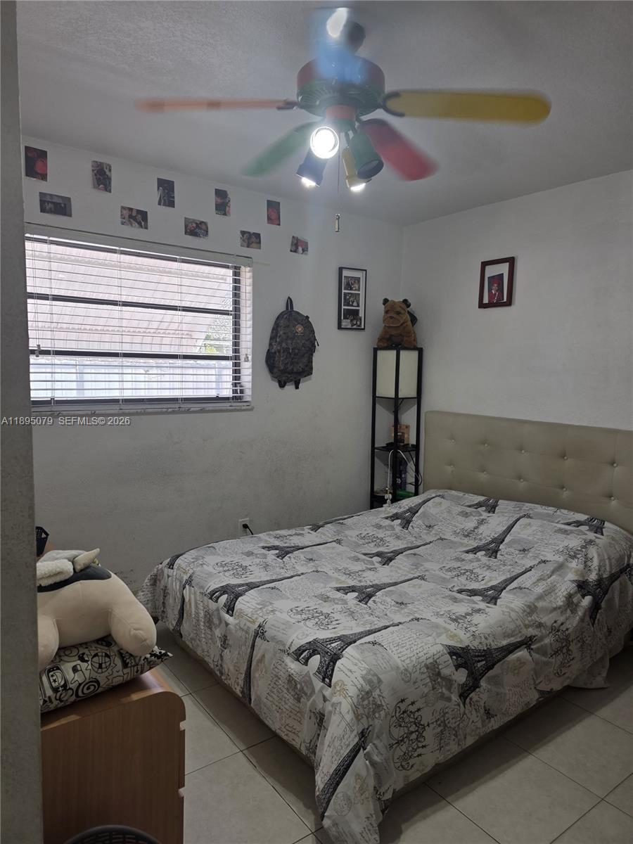 12941 Auralia Road North Miami, FL 33181 - Photo 14 of 32 a bedroom with a bed and window