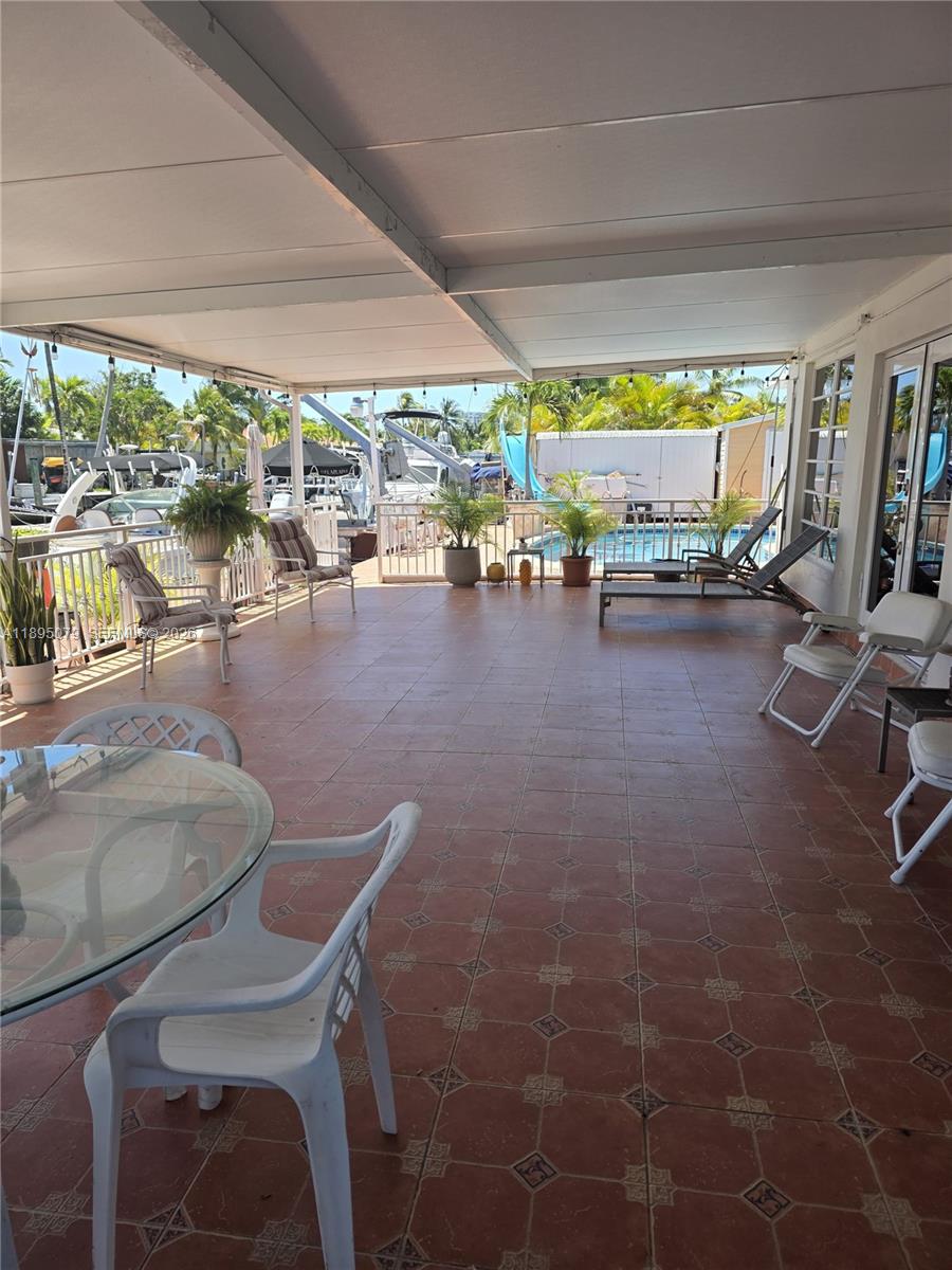 12941 Auralia Road North Miami, FL 33181 - Photo 19 of 32 a room with lots of furniture and garden view