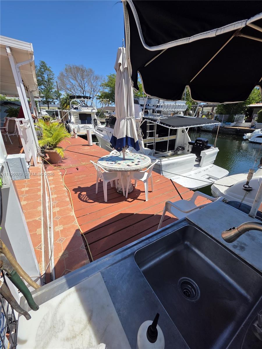 12941 Auralia Road North Miami, FL 33181 - Photo 20 of 32 a view of a patio with chairs and a table