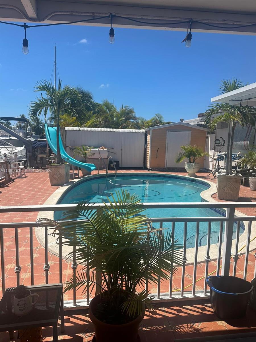 12941 Auralia Road North Miami, FL 33181 - Photo 22 of 32 a backyard of a house with outdoor seating