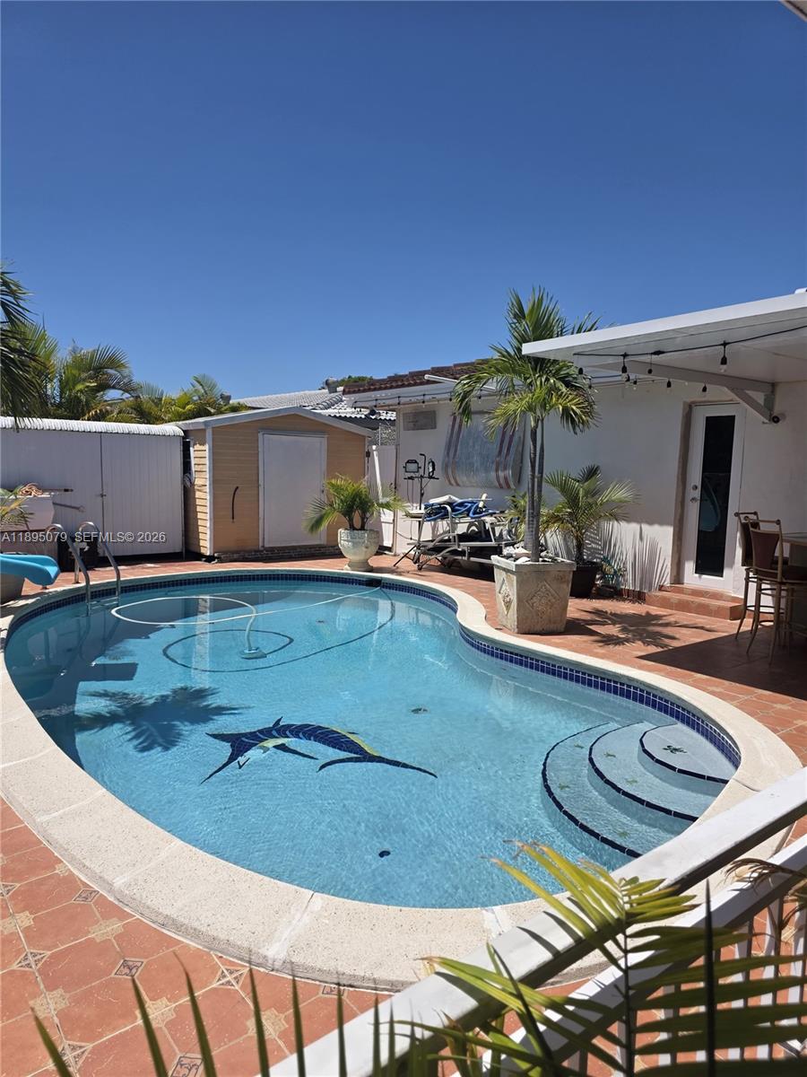 12941 Auralia Road North Miami, FL 33181 - Photo 25 of 32 a view of a swimming pool with a patio
