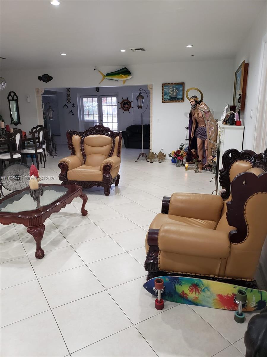 12941 Auralia Road North Miami, FL 33181 - Photo 26 of 32 a living room with furniture and a mirror