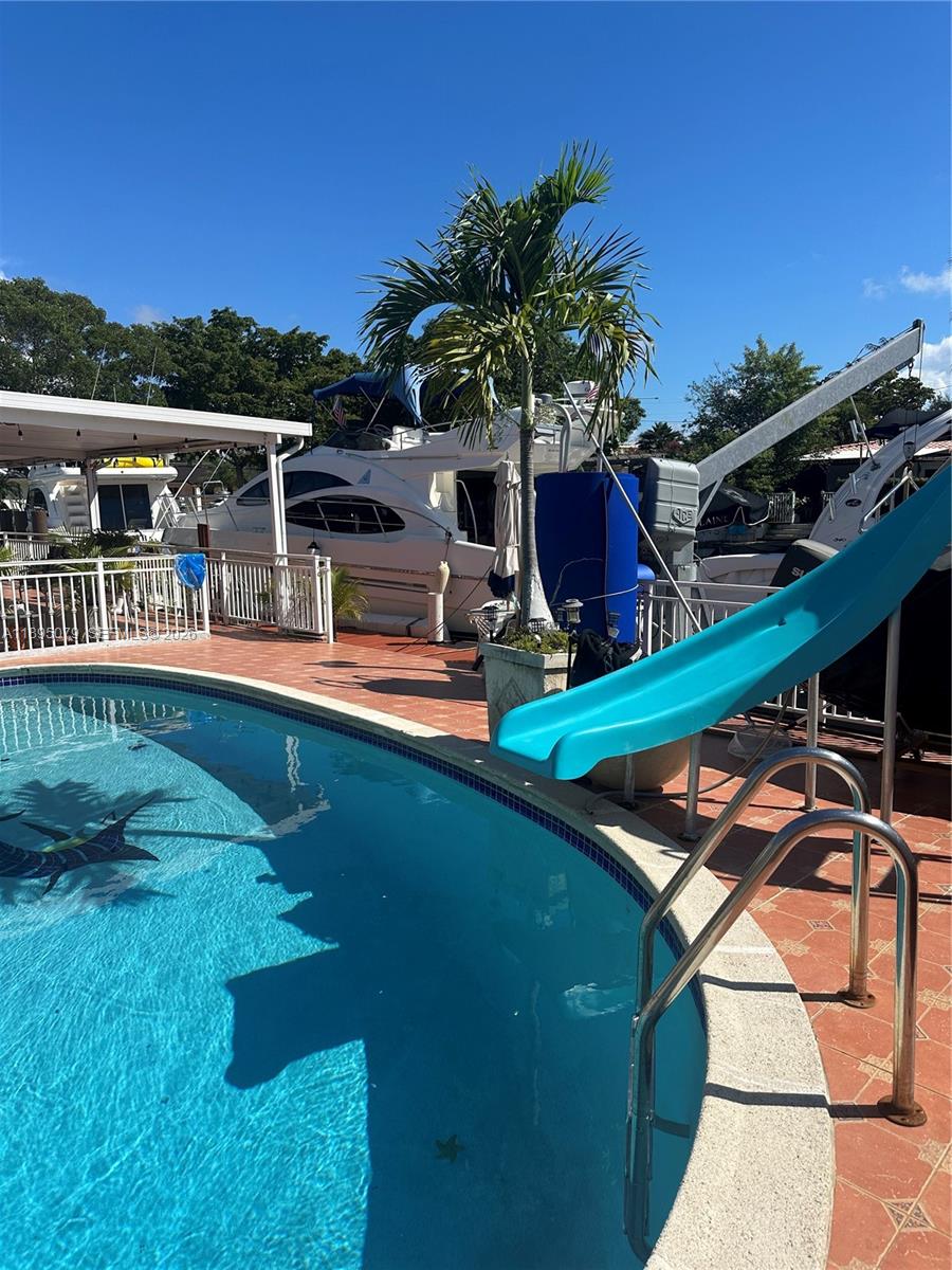 12941 Auralia Road North Miami, FL 33181 - Photo 3 of 32 a view of a house with pool