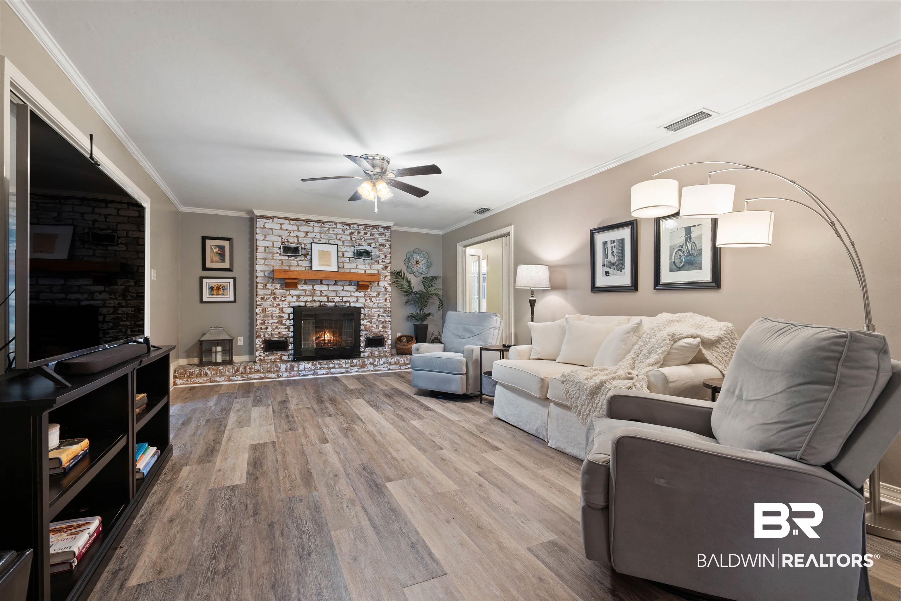 4051 East Canal Circle Mobile, AL 36619 - Photo 5 of 32 Living room featuring ornamental molding, a brick fireplace, ceiling fan, and hardwood / wood-style floors