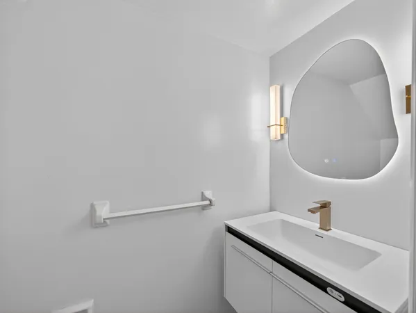 a bathroom with a granite countertop sink a mirror and a shower