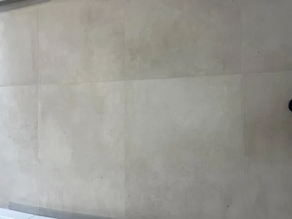 a front view of a house with a garden and trees