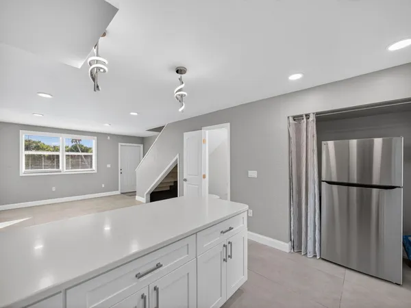 a kitchen with stainless steel appliances a stove a sink and a refrigerator
