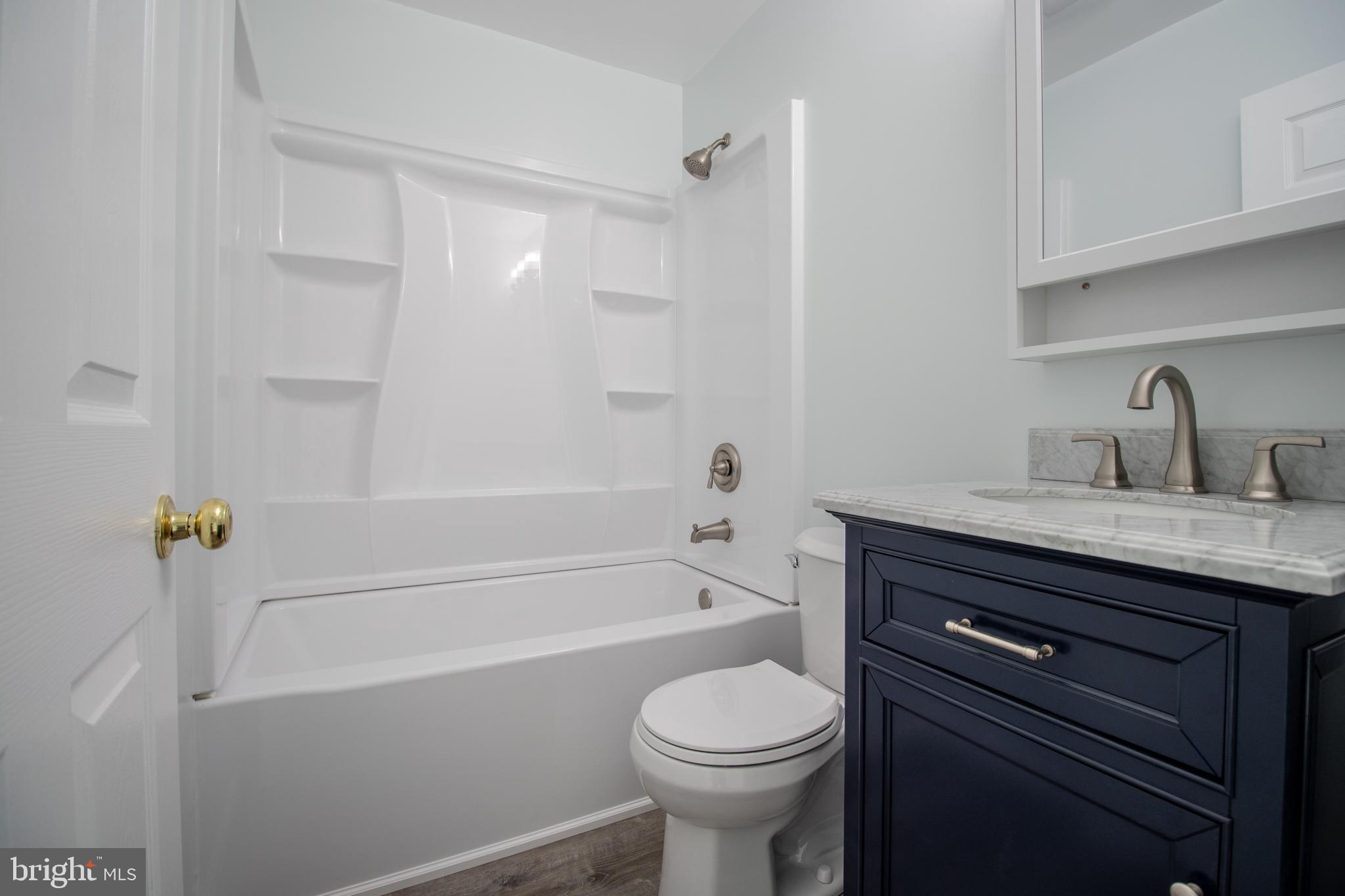 1311 Hallock Drive Odenton, MD 21113 - Photo 16 of 18 a bathroom with a sink a toilet and bathtub