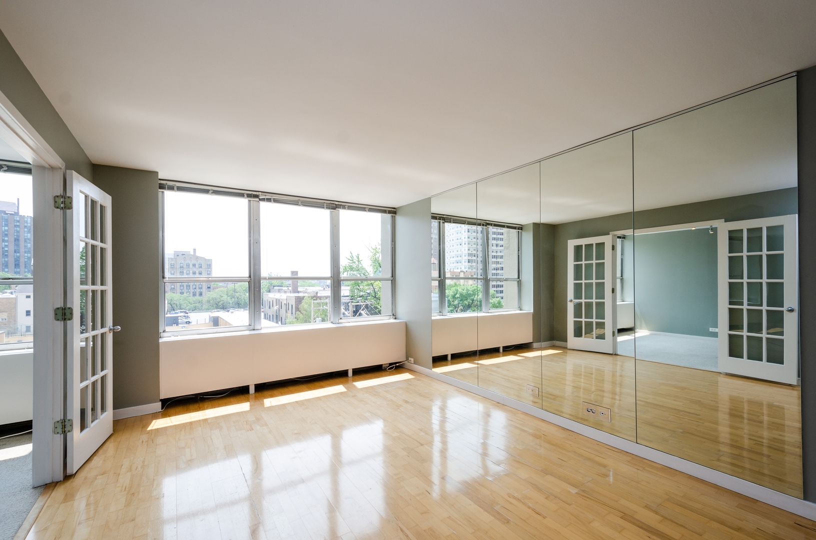 655 West Irving Park Road, Unit 407 Chicago, IL 60613 - Photo 2 of 31 a view of an empty room with wooden floor and a window