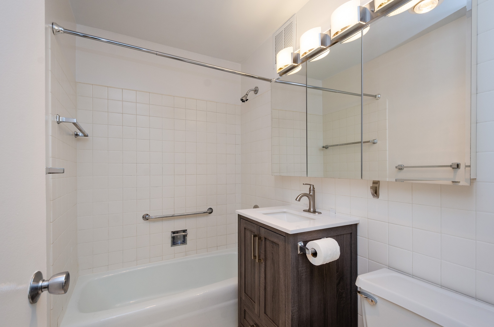 655 West Irving Park Road, Unit 407 Chicago, IL 60613 - Photo 9 of 31 a bathroom with a sink a toilet and shower