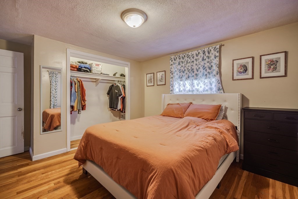 76 Wilshire Road Springfield, MA 01118 - Photo 14 of 34 a bedroom with a large bed and a closet