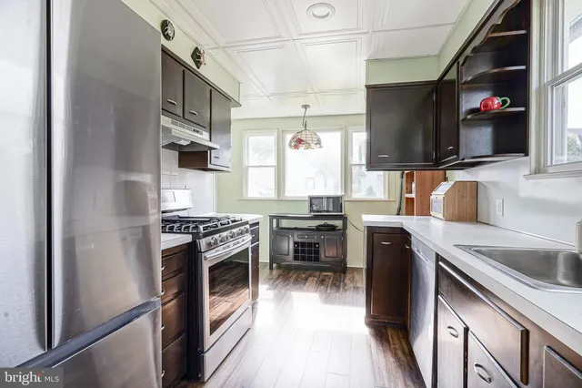 a kitchen with stainless steel appliances granite countertop a stove and a refrigerator