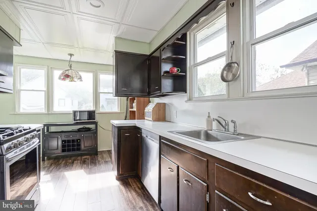 a kitchen with a sink cabinets and window