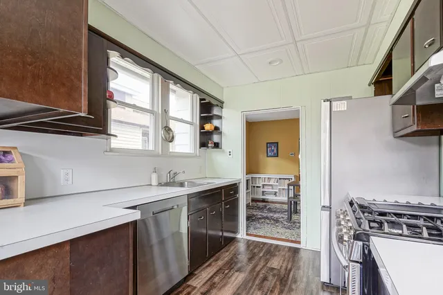 a kitchen with stainless steel appliances a sink stove and cabinets