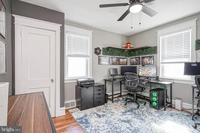 a view of a workspace with furniture and a window