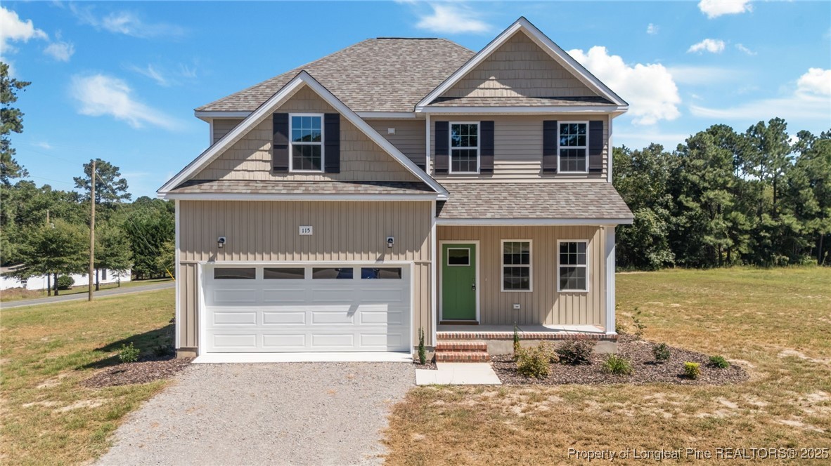 115 Gilchrist Road Carthage, NC 28327 - Photo 1 of 42 a front view of a house with a yard and garage
