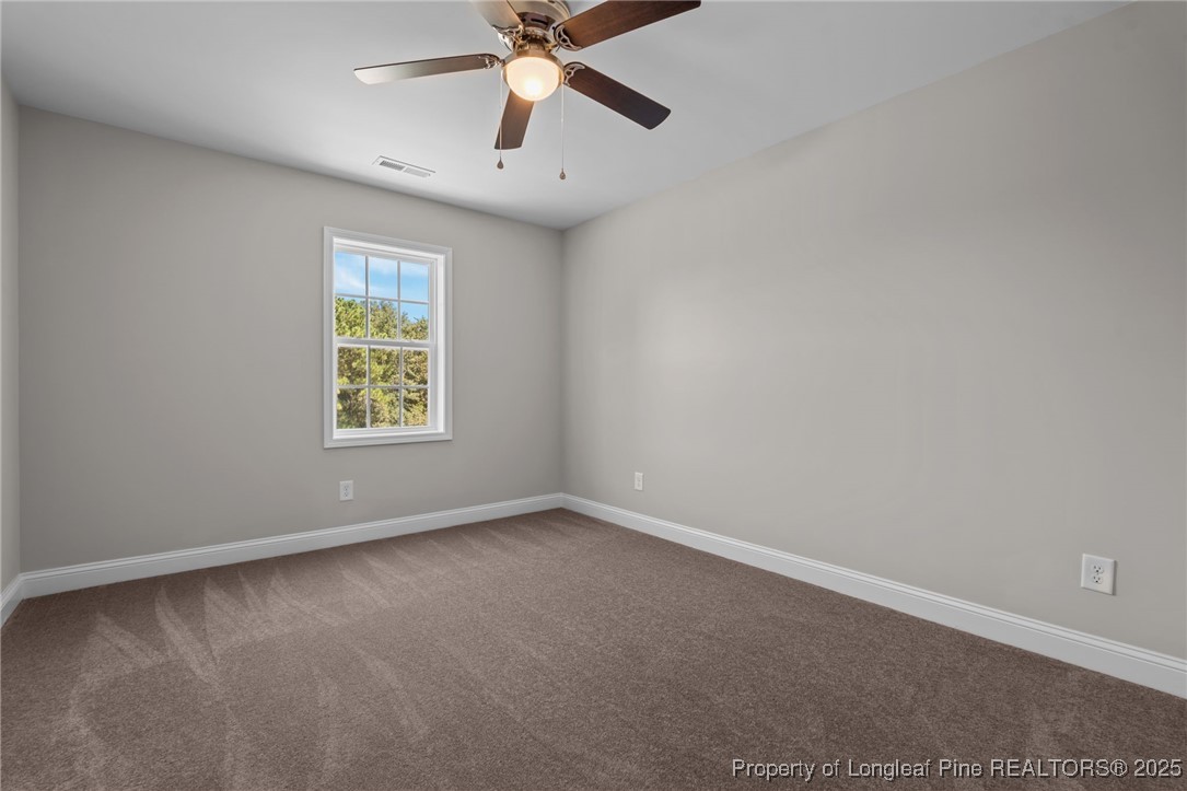 115 Gilchrist Road Carthage, NC 28327 - Photo 23 of 42 an empty room with a window and a fan