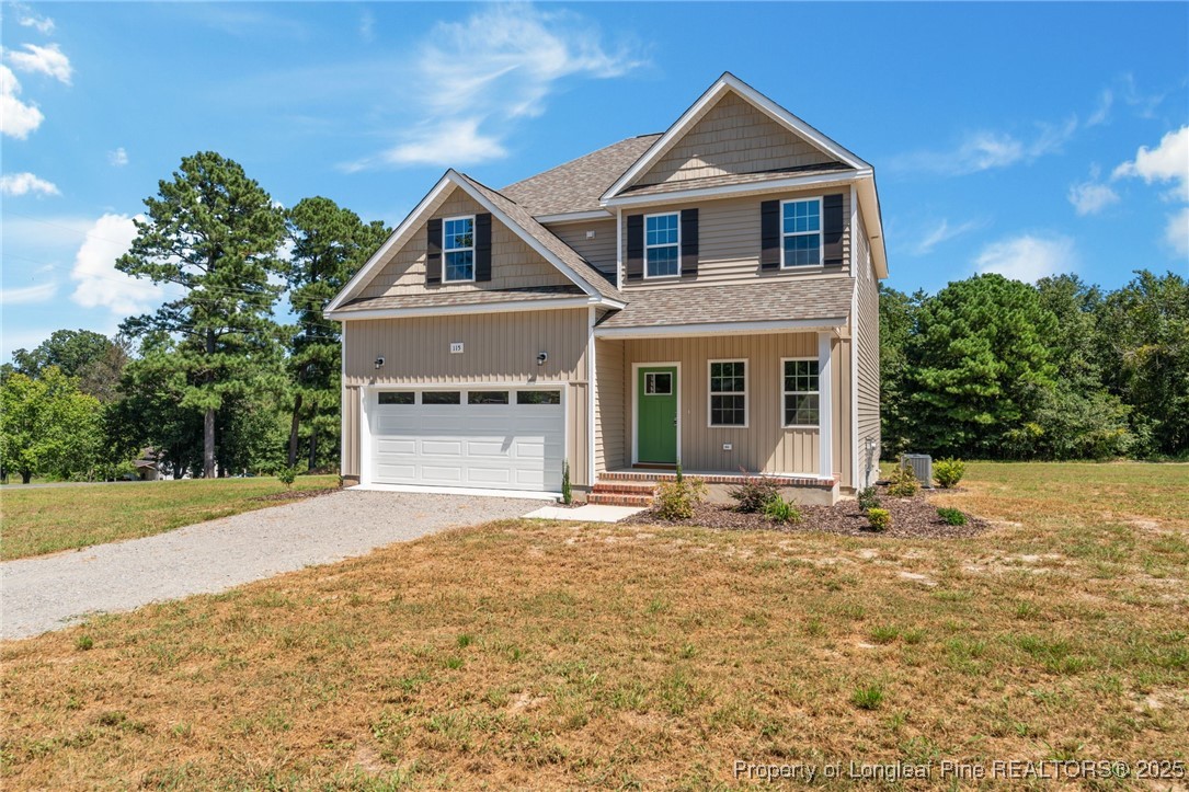 115 Gilchrist Road Carthage, NC 28327 - Photo 4 of 42 a front view of a house with a yard and garage