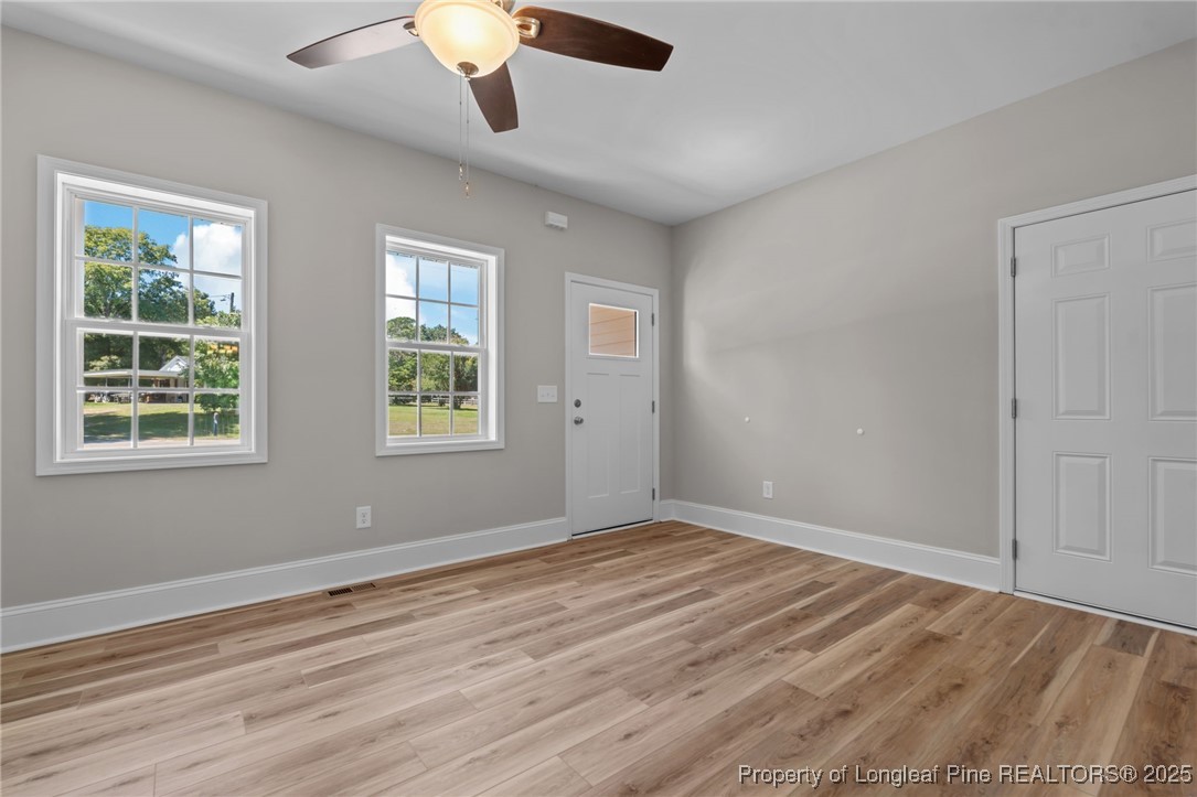 115 Gilchrist Road Carthage, NC 28327 - Photo 6 of 42 a view of an empty room with wooden floor and a window