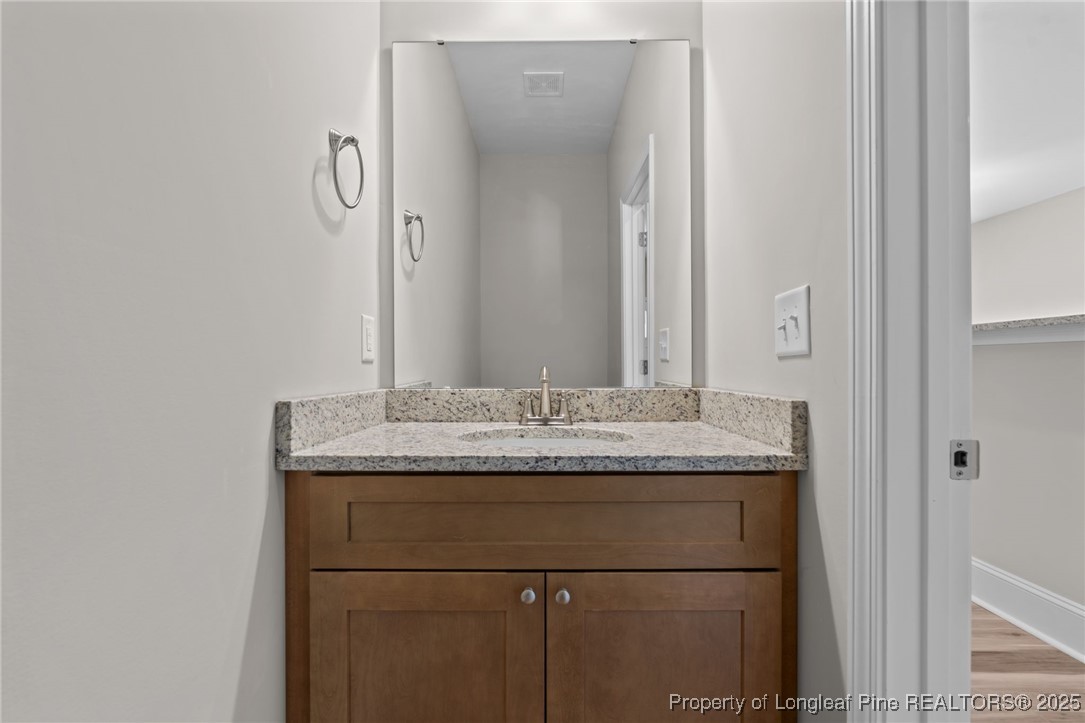 115 Gilchrist Road Carthage, NC 28327 - Photo 8 of 42 a bathroom with a granite countertop sink and a mirror
