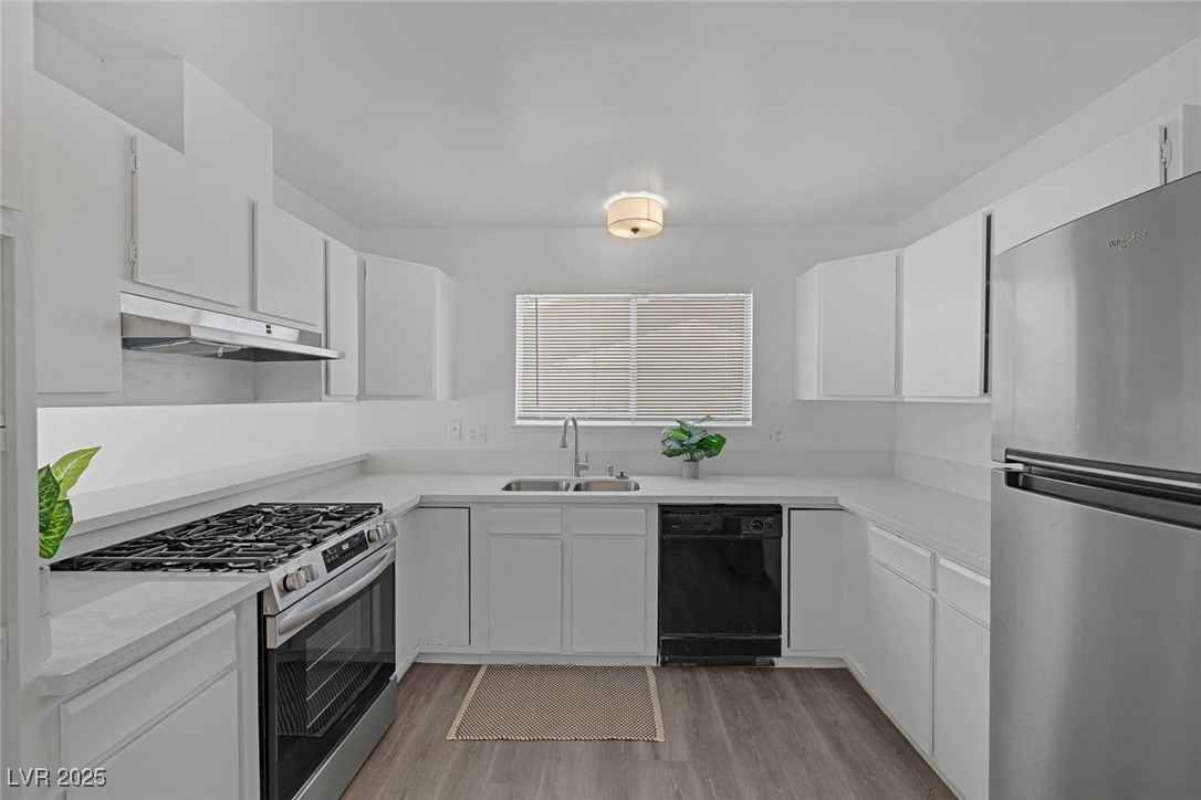 720 Sam Jonas Drive Las Vegas, NV 89145 - Photo 12 of 34 Kitchen with white cabinets, stainless steel appli