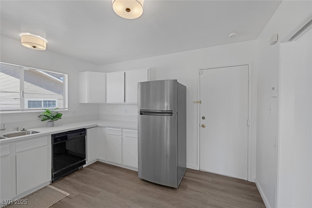 720 Sam Jonas Drive Las Vegas, NV 89145 - Photo 15 of 34 Kitchen with black dishwasher, freestanding refrig