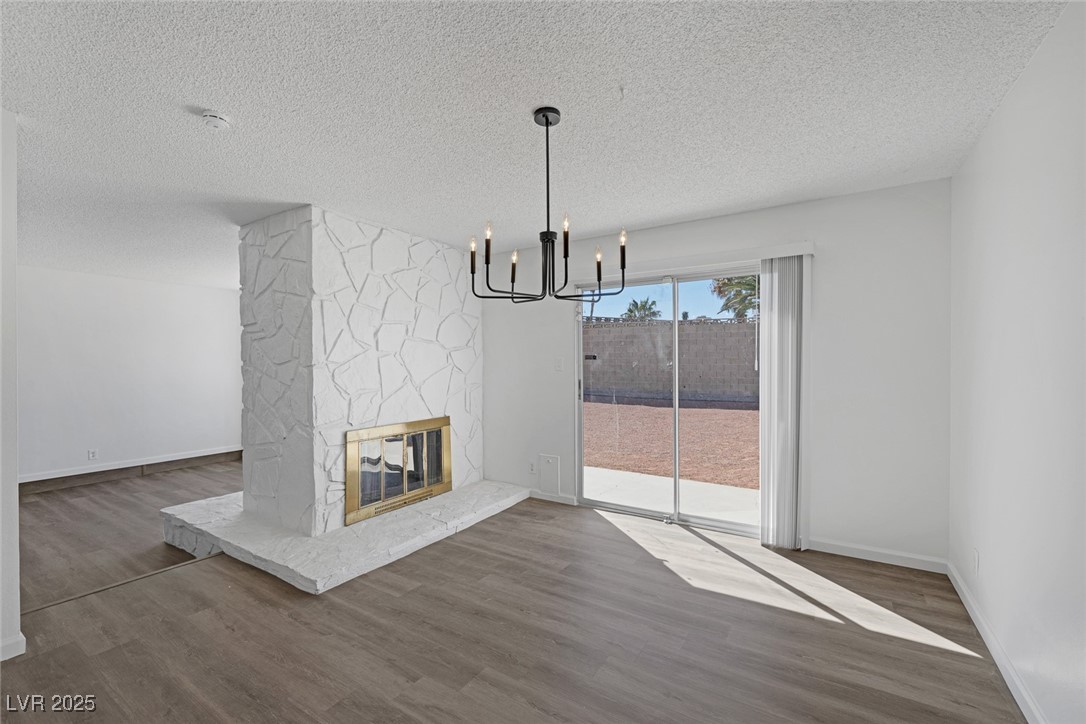 720 Sam Jonas Drive Las Vegas, NV 89145 - Photo 17 of 34 Unfurnished dining area with a stone fireplace, an