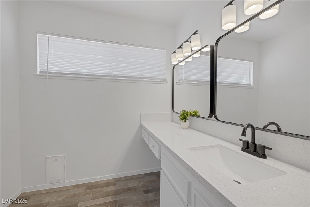 720 Sam Jonas Drive Las Vegas, NV 89145 - Photo 20 of 34 Bathroom featuring baseboards, vanity, and wood fi